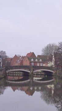 Zoom in shot towards the historic Fye Bridge over the River Wensum in the city of Norwich. Vertical format footage optimized for shorts, reels and social media use