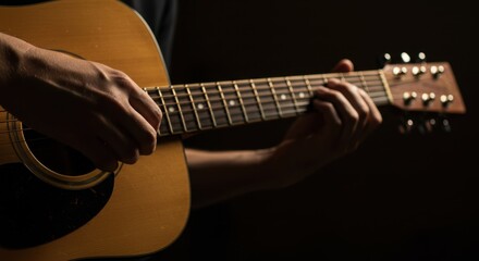 Fototapeta premium Close-up of Guitarist's Hands Playing Acoustic Guitar