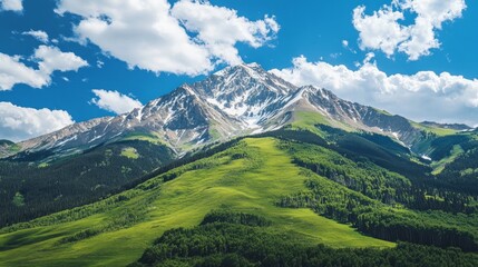 Obraz premium Majestic Mountain Range Surrounded by Lush Green Hills and Clouds