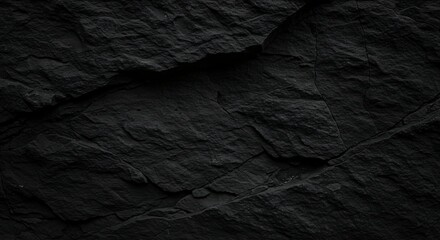 Fototapeta premium Black abstract background. Grunge background with copy space. The surface of the mountain close-up. Dark gray stone background. Rock texture.