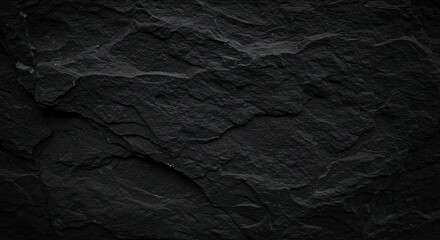 Fototapeta premium Black abstract background. Grunge background with copy space. The surface of the mountain close-up. Dark gray stone background. Rock texture.