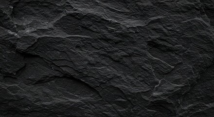 Fototapeta premium Black abstract background. Grunge background with copy space. The surface of the mountain close-up. Dark gray stone background. Rock texture.
