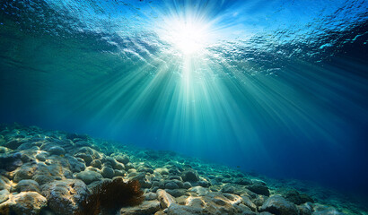 Tranquil underwater scene with sun rays and clear blue ocean. Royalty high-quality free best stock of Underwater scene with rays of light shining down on the ocean, abstract background