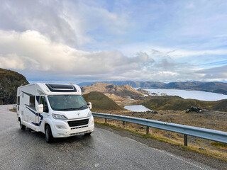 RV Motorhome parked on a nordkapp scenic highway with mountains in norway