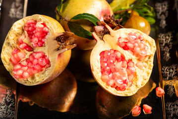 Pomegranates, beautiful freshly picked pomegranates on a wonderful tray on a rustic surface,...