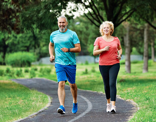 woman mature man outdoor running couple sport together jogging healthy mid adult nature fit active exercise fitness run park middle age