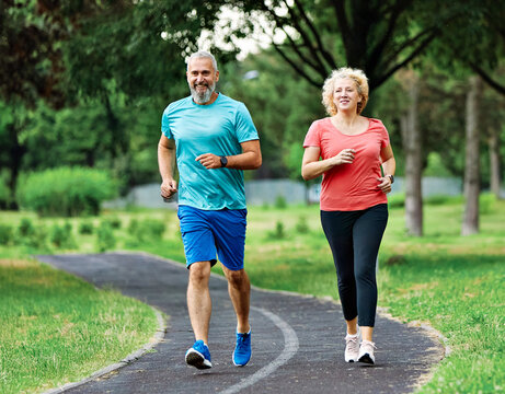 woman mature man outdoor running couple sport together jogging healthy mid adult nature fit active exercise fitness run park middle age