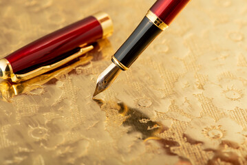 Fountain pen, beautiful fountain pen on an old metal surface with beautiful embossed ornaments,...