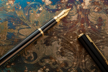 Fountain pen, beautiful fountain pen on an old metal surface with beautiful embossed ornaments,...
