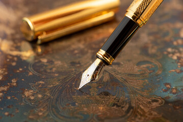 Fountain pen, beautiful fountain pen on an old metal surface with beautiful embossed ornaments,...