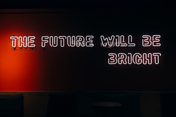 Neon sign phrase The future will be bright on black background isolated.