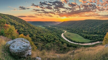 Scenic sunrise over a meandering river in a lush valley.