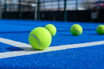 blue paddle tennis court, a ball on the line. Racket sport concept background