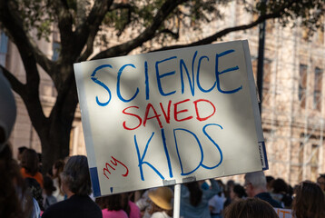 Bold, impactful rally signs from the "Save the Sciences" protest featured messages like "Science Saves Lives," "Facts Over Fiction," and "Defend Research," advocating for funding, truth, and progress.