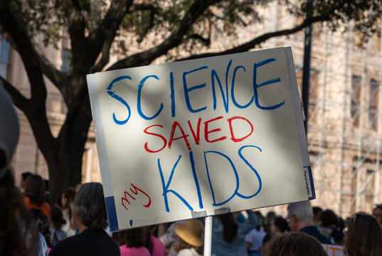 Bold, impactful rally signs from the "Save the Sciences" protest featured messages like "Science Saves Lives," "Facts Over Fiction," and "Defend Research," advocating for funding, truth, and progress.