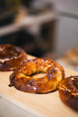 Freshly baked bagel with cherries in a bakery on a display window.