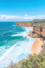 Fototapeta premium Dramatic coastline with crashing waves and untouched golden sands along a deep blue ocean under a bright sky