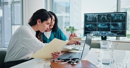 Women, doctors and meeting with x ray, laptop and review for documents, team or plan dental surgery at clinic. Mentor, surgeon and dentist with teeth, jaw injury and analysis in hospital boardroom