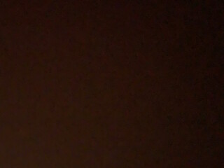 A dark, low-detail view of what seems to be a solid-colored surface. With no distinguishable features, it could be seen as a dark surface in dim lighting, an underexposed photograph