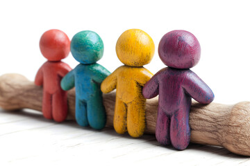 four wooden figurines painted in vibrant colors standing on a branch