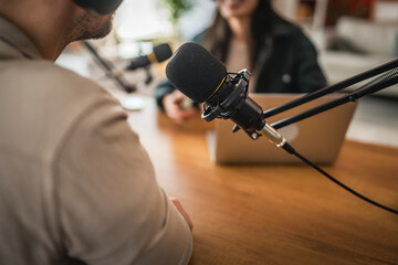 close up on microphone and laptop at home studio, podcast concept