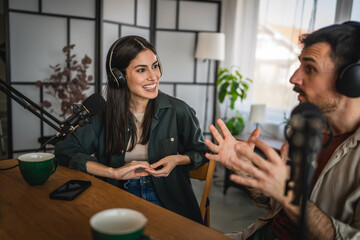 two young adult hosts record together podcast in home studio