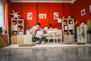 focus man read instructions to install cabinet at his new home