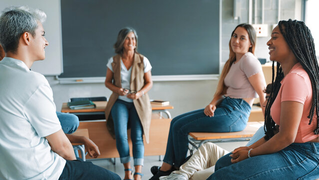 Multi-ethnic hispanic latin and African American students teacher a support debate conversation with teacher during a class in high school