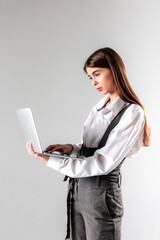 Professional woman working on laptop in a minimalist indoor space during daytime
