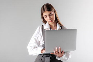 Young professional engages with a laptop in a modern studio setting during a work session