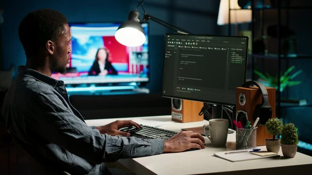 African american man working on PC to write code and programming in artificial intelligence and deep learning. Male IT engineer using pc to ensure cyber security, neural network. Camera B.