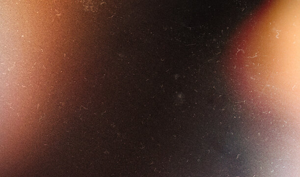 grainy colorful warm orange light leaks on black background with dust texture. abstract damaged scratched retro film analog effect for using over photos as overlay or screen filter