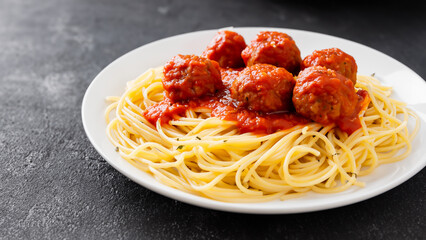 Delicious appetizing classic spaghetti pasta with tomato sauce, on a background.
