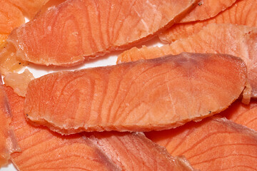 Slicing frozen trout fillets for the festive table. Homemade food. Close-up.