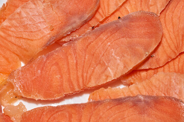 Slicing frozen trout fillets for the festive table. Homemade food. Close-up.