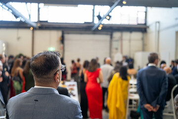 people watching at an event inside