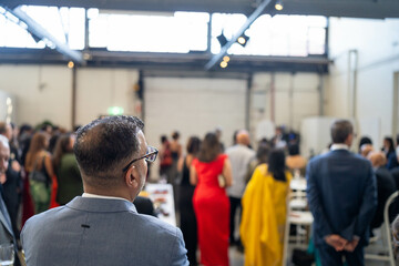 people watching at an event inside