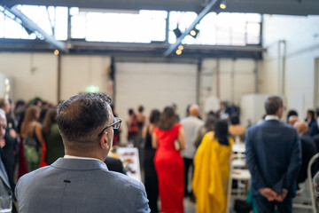 people watching at an event inside