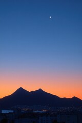 Dusk view of mountains over city