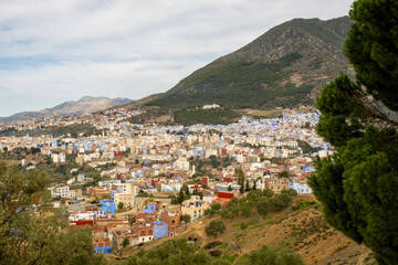 A picturesque scene of the "Blue City" of Chefchaouen, with its unique architecture and stunning mountain backdrop.