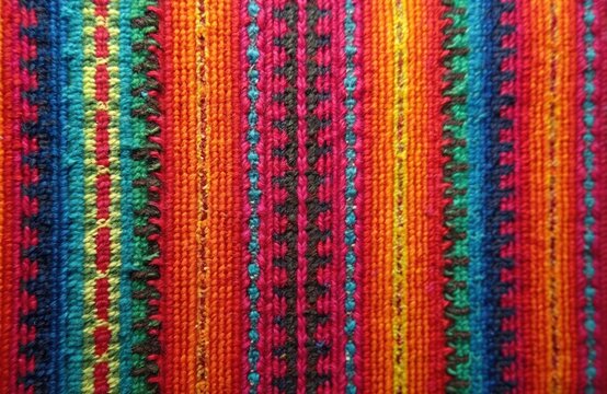 Closeup of colorful woven Andean textile with vibrant stripes. Traditional Inca fabric texture from South America. Ethnic wool cloth pattern, vintage handmade background. Use for fashion, decor,