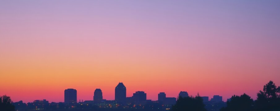 A beautiful cityscape silhouetted against a colorful sunset sky