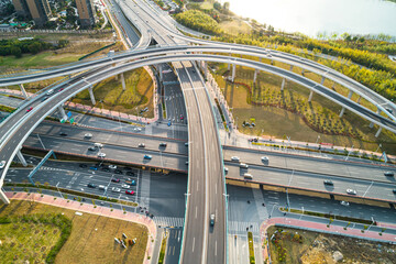 Urban highway interchange showcases modern infrastructure and busy traffic flow in a bustling city environment