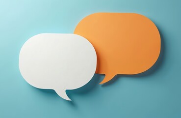 Two blank color paper speech bubbles for your design. White and orange dialogs on blue background. Flat lay top view, discussion template. Communication concept, place for talk, idea and text.