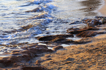 Europe, Spain, Balearic Islands, Mallorca. Porto Colom. Beach waves at sunset.
