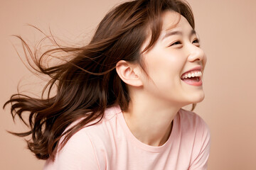 Woman smiling with her hair blowing softly in the wind, AI-generated