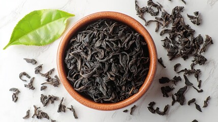 Loose Black Tea Leaves in Bowl on Marble