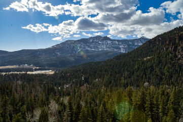 Mountain ranges and trees on a clear partly-cloudy sunny day in southwestern Colorado, USA