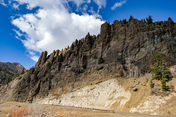 Mountain ranges and trees on a clear partly-cloudy sunny day in southwestern Colorado, USA