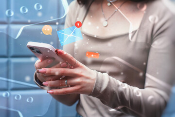 A girl holds a smartphone with an overlay of social media icons. Communication and social connection on the internet.